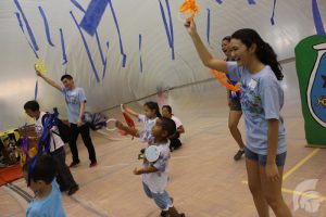 (Photo courtesy of assistant student activities coordinator Danielle Castro) As one of the playday activities, Senior Laura Ambrosecchio (right) and Junior Austin Ajimura, led singing, dancing and games within a plastic bubble that students and preschoolers could stand inside.