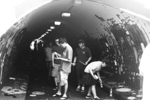 (Caitlyn Resurreccion | Trojan Times) Every year, volunteers from the Mililani community gather to paint over the graffiti in the Kipapa tunnel. While last year's theme was "Under the Sea," this year's theme is "Space." 