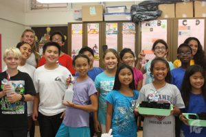 (Risa Askerooth | Trojan Times) Students at Mililani Uka were able to learn the proper way to plant koa with the high school students that were visiting that day, Samantha Alvarado (12), Nicole Antos (12), Risa Askerooth (11) and Vanessa Roybal (11). 