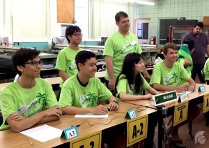 (Photo courtesy of Betty Arai) Mick Marchan (12), Zachary Higa (10), Shawn Kim (12), Science club adviser Matthew Capps, Vivian Fang (12) and John Carson (11) prepare for competition in their bracket against Iolani School and Farrington High School at the Honolulu Community College.