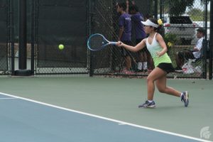 (Harlan Rose | Trojan Times) At the Oahu Interscholastic Association championships, some competed in doubles matches, where they went up against their opponents with a partner, while others, such as Haley Fujimori (10), competed in singles matches. 