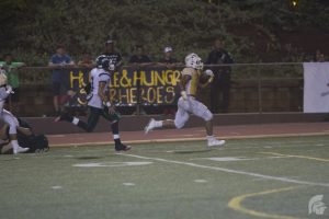 (Matthew Kawamoto | Trojan Times) At this year's Homecoming Game, Running Back Vavae Malepeai (12) added 65 receiving and 56 rushing yards to create a total record of 106 completed yards for this season and 639 completed yards for his high school career. 