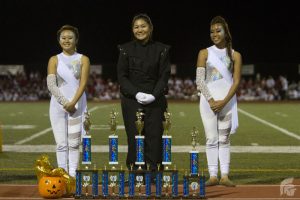 (Kelikoaelakauaikekai Gongob | Trojan Times) (L-R): Lauren Iwasaki (11), Kimberly Tsuha (12), Jerika Gomez (12) represent the MHS Marching Band and Color Guard after awards were given.