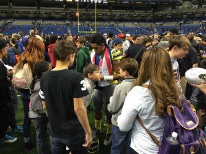 (Photo courtesy of Tali Malepeai) After playing in the All-American game the tired but happy Vavae Malepeai (12) stayed hours later to sign autographs for some of his devoted and loyal fans; the fans remained on the field until asked to leave by security.