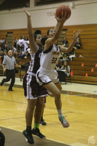 (Scott Alquisa | Na Manao Poina Ole) Guard Jazmina Lafitaga (12) goes for a layup against Farrington, scoring another point for her team and helping propel the season forward.